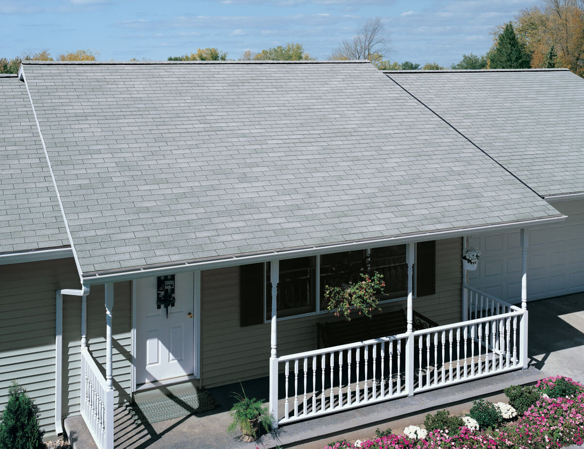 A residential home with a front porch in Limerick, PA featuring a newly installed light gray asphalt shingle roof by ELR Roofing.