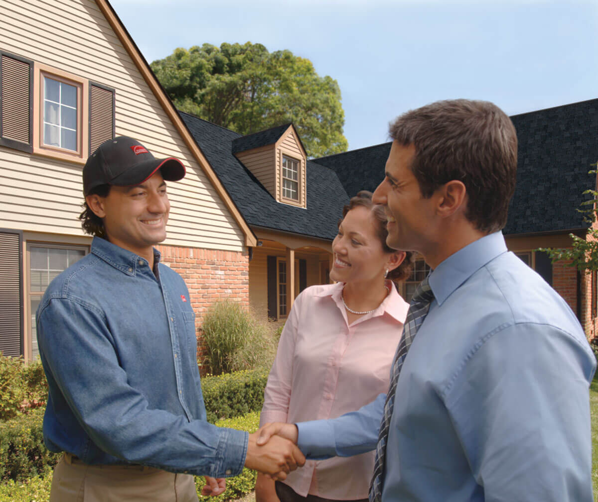 A trusted ELR Roofing contractor shaking hands with a satisfied homeowner in Phoenixville, PA after a successful roof replacement.